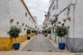View of a nice street of a typical white Andalusian town, decorated with flower pots, Royalty Free Stock Photo