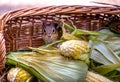 Chipmunk hides in a basket of corn