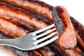 Close up on a chipolata stuck on a fork