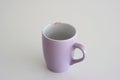 Chipped coffee mug on white background, shallow depth of field