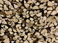 Chipped dry firewood is ready for winter. Background of logs, birch, pine and oak. Wall of chopped firewood for heating Royalty Free Stock Photo