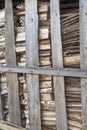 Chipped wood and sawn wood waste, stacked behind a partition of old planks. The concept of nature protection.