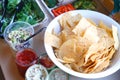 Chips in bowl, sauce and green vegetable salad