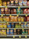 Chips line the aisle of a grocery store