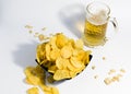 Mug of light beer, with crispy potato chips and peanuts, on a white background. food for a quick snack to beer. Royalty Free Stock Photo