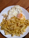 Chips plate with a fried egg Royalty Free Stock Photo