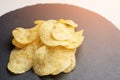 Chips from potato on the tray with tinted sunlight