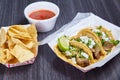 Chips red salsa street taco meal 3 corn tortilla lengua cow beef tongue Mexican lime wedge Royalty Free Stock Photo