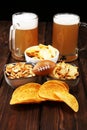 Chips, salty snacks, football and Beer on a table. Great for Bowl Game projects
