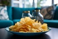 Chips snack, prominently placed on a coffee table in a chic blue decorated lounge