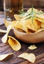 Chips in a wooden bowl and beer Royalty Free Stock Photo