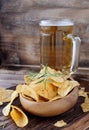 Chips in a wooden bowl and beer Royalty Free Stock Photo