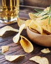 Chips in a wooden bowl and beer Royalty Free Stock Photo