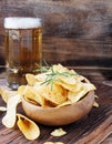 Chips in a wooden bowl and beer Royalty Free Stock Photo