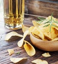 Chips in a wooden bowl and beer Royalty Free Stock Photo