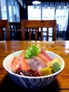 Chirashi sushi donburi in a bowl on a wooden table