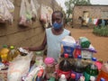 Boy with face mask at a backyard grocery stall.