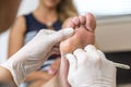 Beautician foot treatment.Treatment of feet and nails. Royalty Free Stock Photo