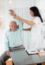 Chiropractic: Chiropractor examining senior man at office