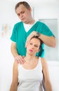 Chiropractor adjusting neck muscles Royalty Free Stock Photo