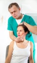 Chiropractor adjusting neck muscles Royalty Free Stock Photo