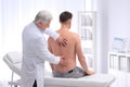 Chiropractor examining patient with back pain Royalty Free Stock Photo