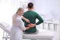 Chiropractor examining patient with back pain Royalty Free Stock Photo