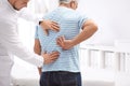 Chiropractor examining patient with back pain Royalty Free Stock Photo