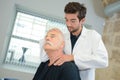 Chiropractor manipulating senior patient's neck Royalty Free Stock Photo