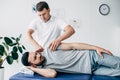 Chiropractor massaging arm of patient on massage table Royalty Free Stock Photo