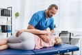 chiropractor massaging back of patient that lying on massage table Royalty Free Stock Photo