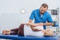 chiropractor massaging back of patient that lying on massage table Royalty Free Stock Photo