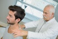 Chiropractor working on young man`s back