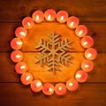 Chirstmas candles circle over wood and symbol Royalty Free Stock Photo