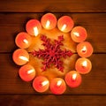 Chirstmas candles circle over wood and symbol Royalty Free Stock Photo