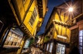 A Chirstmas night view of Shambles, a historic street in York featuring preserved medieval timber-framed buildings with jettied