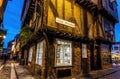 A Chirstmas night view of Shambles, a historic street in York featuring preserved medieval timber-framed buildings with jettied