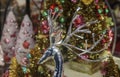 Chirstmas Wonderland - shiny silver deer head with long graceful antlers in front of blurred bokeh colorful trees in holiday setti