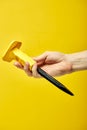 Chisel hand tool closeup on yellow background