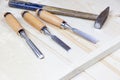 Chisels on a wooden background. Assortment of chisels of wood for carpentry. A set of tools for wood processing Royalty Free Stock Photo