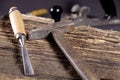 Chisels and hammer on a wooden background. Assortment of chisels of wood for carpentry. Set of chisels. A set of tools for wood Royalty Free Stock Photo