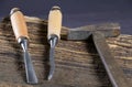 Chisels and hammer on a wooden background. Assortment of chisels of wood for carpentry. Set of chisels. A set of tools for wood Royalty Free Stock Photo