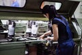 CHISINAU, MOLDOVA - APRIL 26, 2016: Workers in printing house. People working on printing machine in print factory. Industrial wor