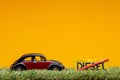 Chisinau, Moldova - August 15th 2019: A car figurine aligned to the left on grass next to a sign which has the word diesel cut