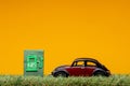Chisinau, Moldova - August 15th 2019: A car figurine aligned to the right on grass next to a pale green sign