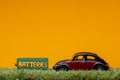 Chisinau, Moldova - August 15th 2019: A car figurine aligned to the right on grass next to a green sign