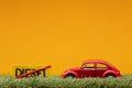 Chisinau, Moldova - August 15th 2019: A red car figurine aligned to the right on grass next to a sign which has the word diesel