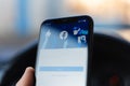 Chisinau, Moldova - 03.12.2019: Close-up of male hand, holding a iPhone 11 with opened Facebook social media app logo on login.