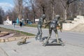 Sculpture of skateboarders with Basset Hound dog sculpture by Petru Glavan
