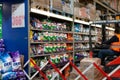 Washing powder brands Dero, Persil, Tide on the shelves of Metro Cash Carry. A worker works